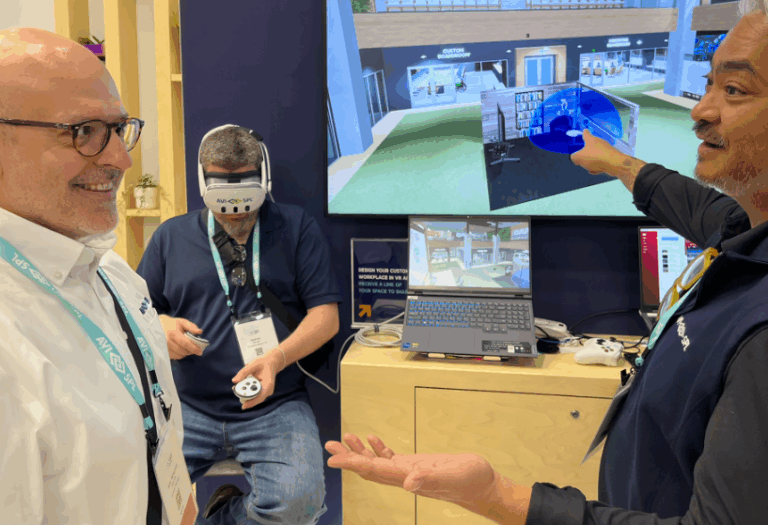 person wearing VR headset, presenter and customer looking at VR design on a display